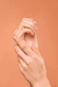 persons hand on orange background